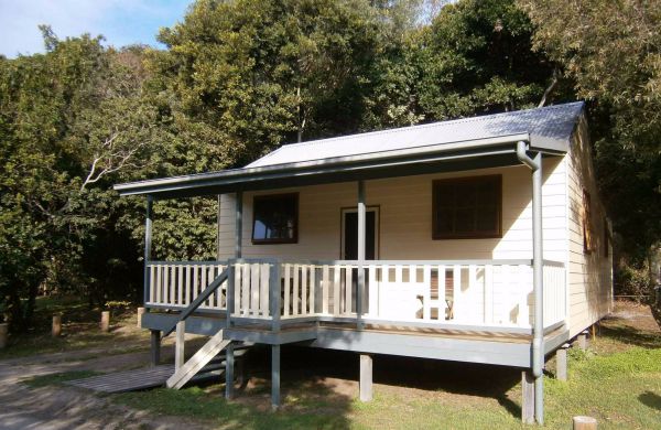 Woody Head Cottages and Cabins Logo and Images